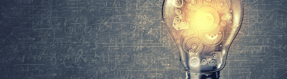 lit up mechanical lightbulb over a dark grey blackboard with math equations